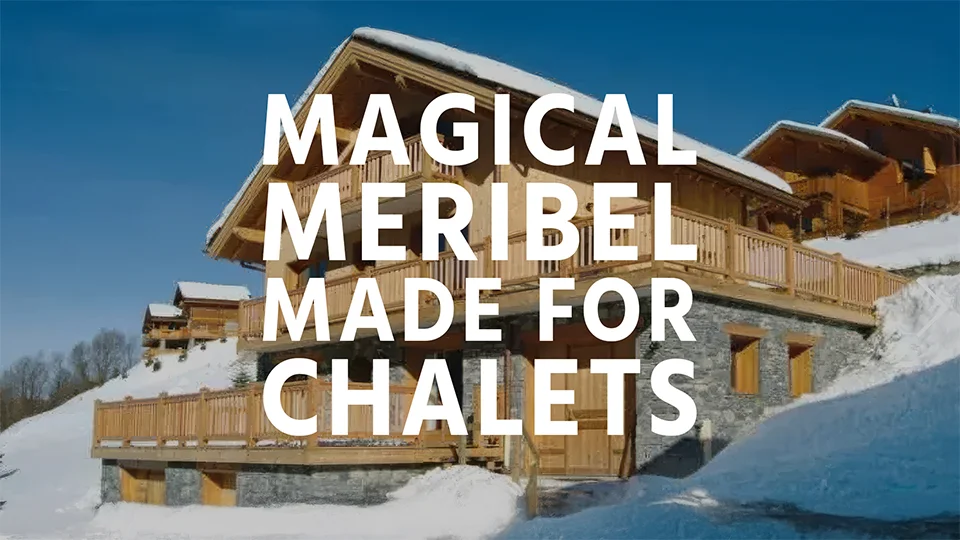 A ski chalet covered in a blanket of snow in Meribel, France with text overlay "Magical Meribel, Made for Chalets"