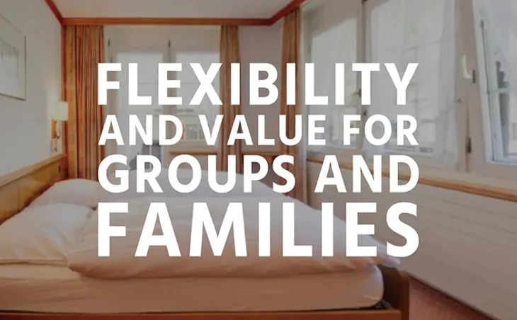 The bedroom interior of a ski apartment in Switzerland, with overlay text "Flexibility and value for groups and families"
