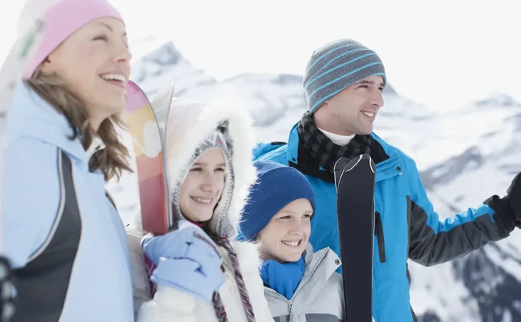 Family Ski Holidays France. A family with young children looking across the Alps mountains