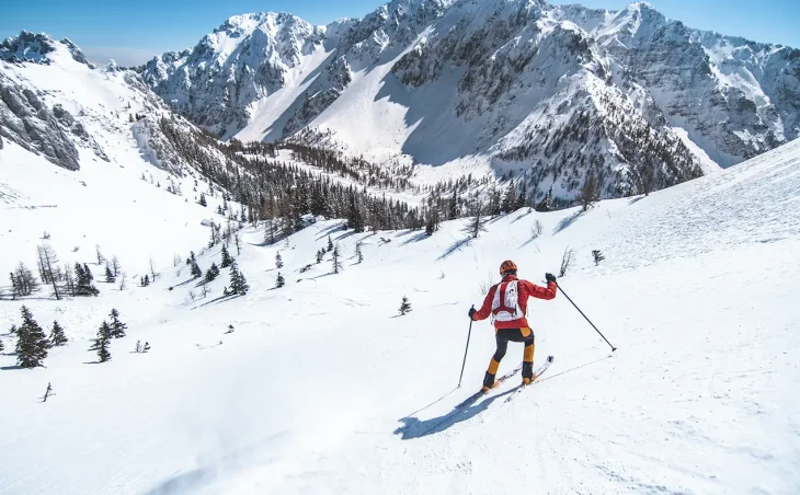 A downhill skier with the Italian Dolomites in the background