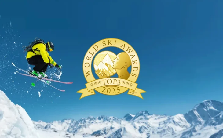 Skier enjoys catching air on ski holiday in Switzerland - with Top 3 World Ski Awards Logo overlay