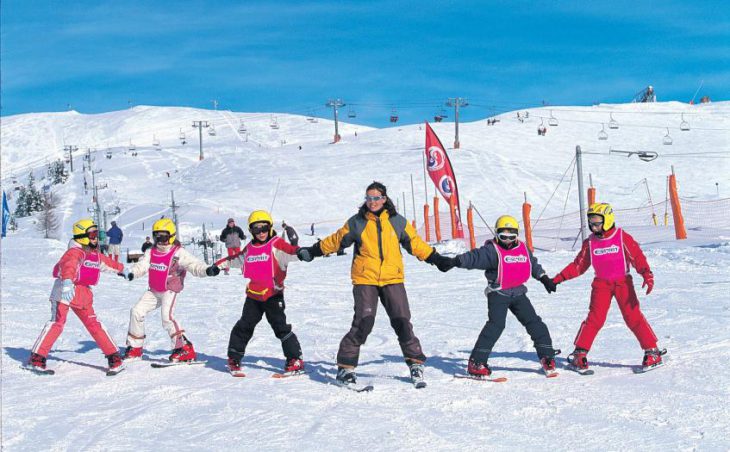 La Rosiere Ski Holidays - A group of young learner skiers holding hands